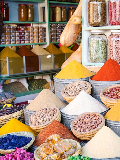 Spices and herbs displayed in Marrakesh Medina souk during guided walking tour.