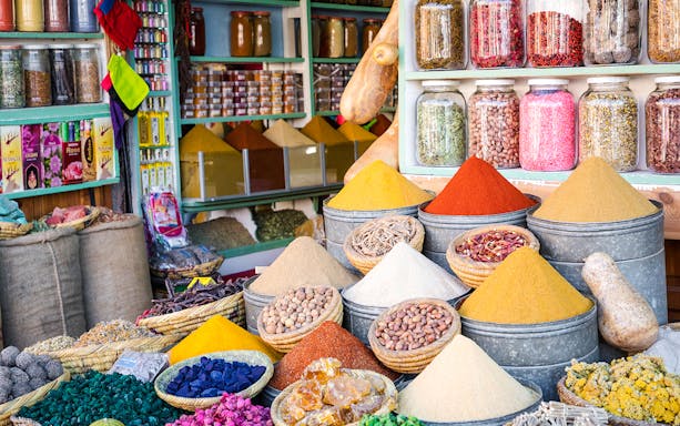 Spices and herbs displayed in Marrakesh Medina souk during guided walking tour.