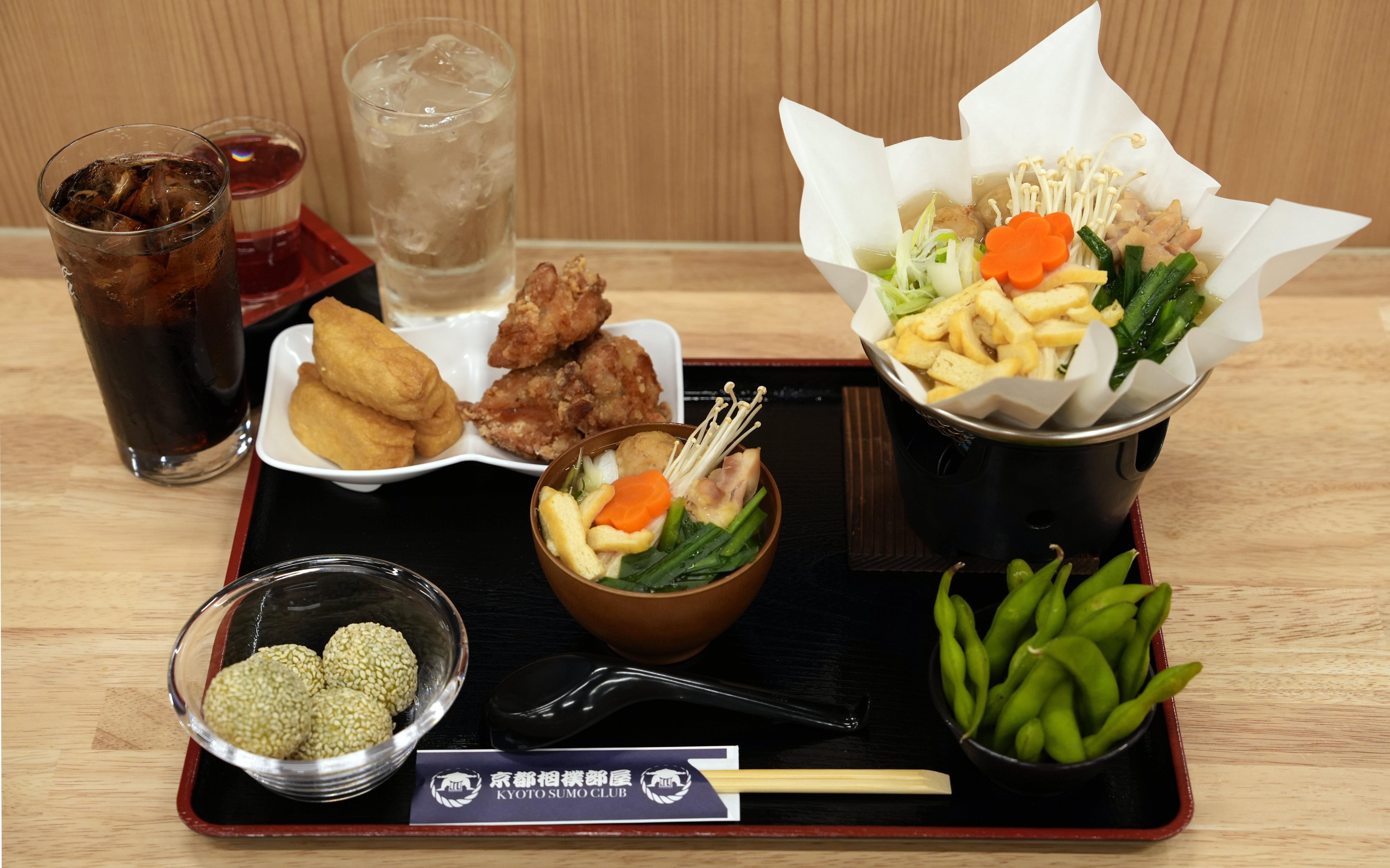 Kyoto Sumo Entertainment Show meal with chicken hot pot, edamame, and drinks.