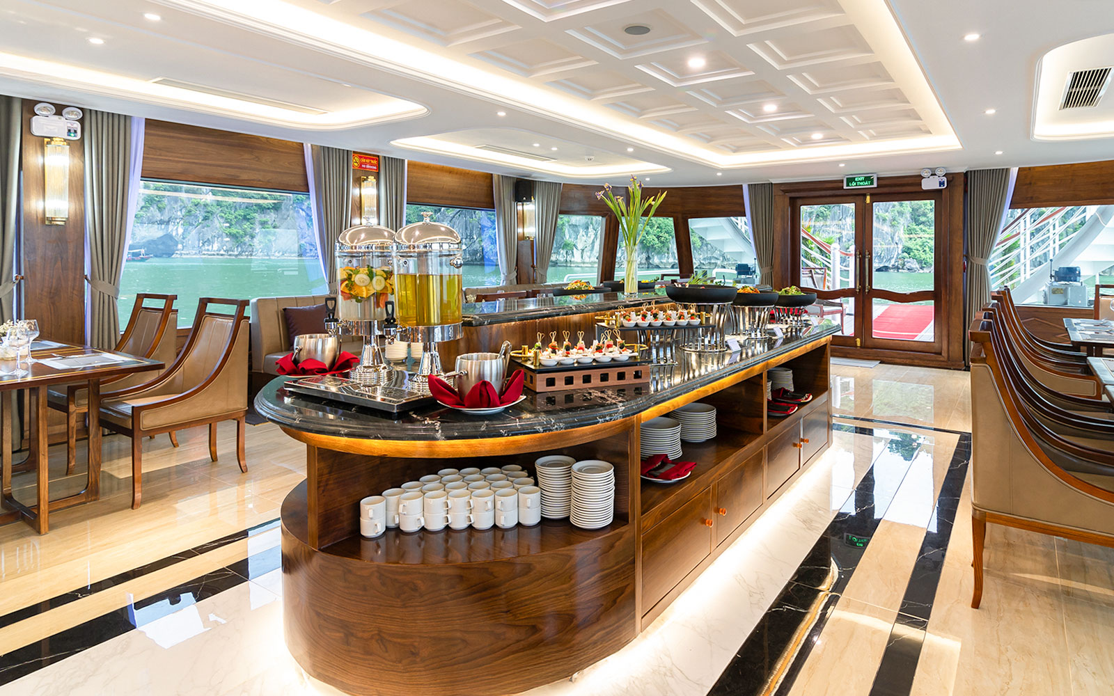 Luxurious dining area on Ha Long Bay 5-Star Cruise with buffet setup and scenic views.