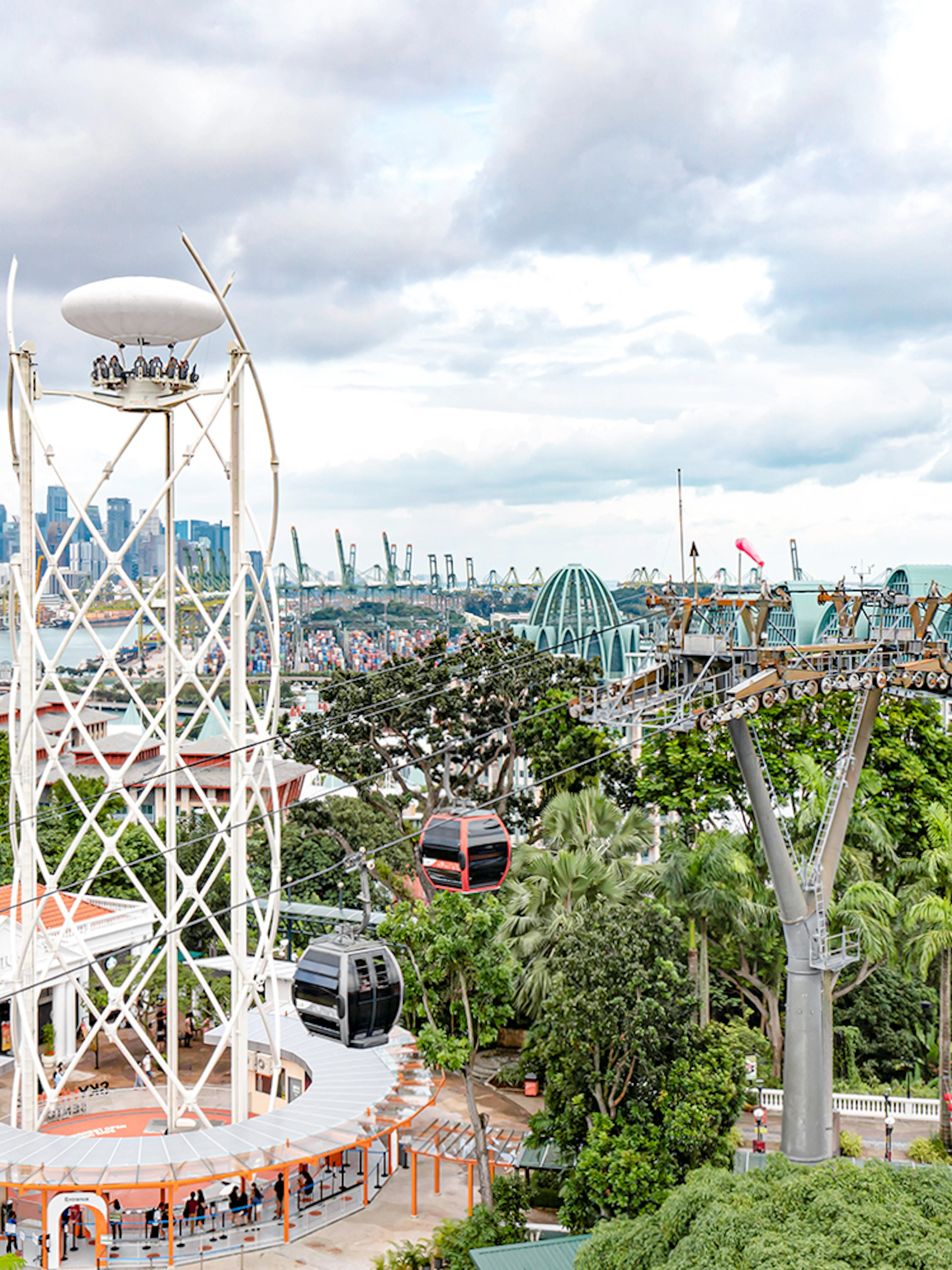 SkyHelix Sentosa ride with panoramic views of Singapore skyline and cable cars.