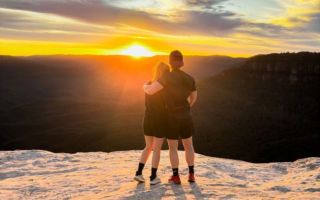 Couple embracing at sunset on Blue Mountains tour.