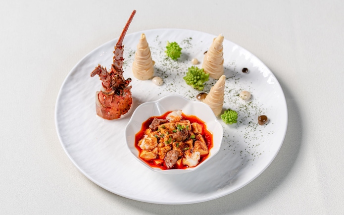 Curated dish at "Taste of China" Immersive Restaurant, Shanghai, featuring lobster and spicy stew.