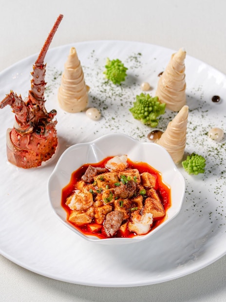 Curated dish at "Taste of China" Immersive Restaurant, Shanghai, featuring lobster and spicy stew.