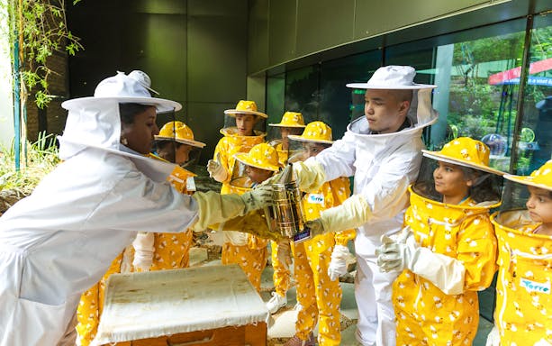 Beekeeping workshop with participants in protective gear at Terra, Expo City Dubai.
