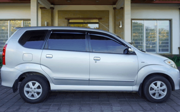 Silver minivan for shared airport transfers from Bali International Airport.