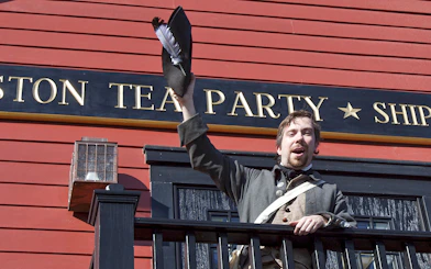 Reenactor in period costume at Boston Tea Party Ship and Museum.
