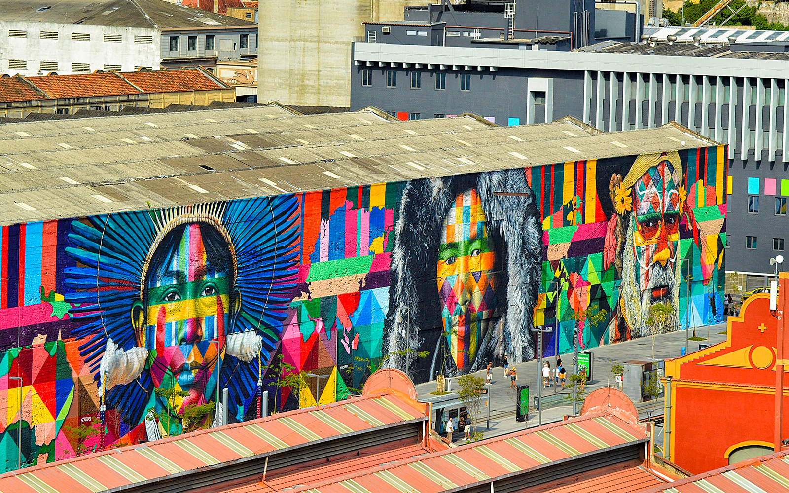 Graffiti mural on Olympic Boulevard featuring colorful portraits on a large building wall.