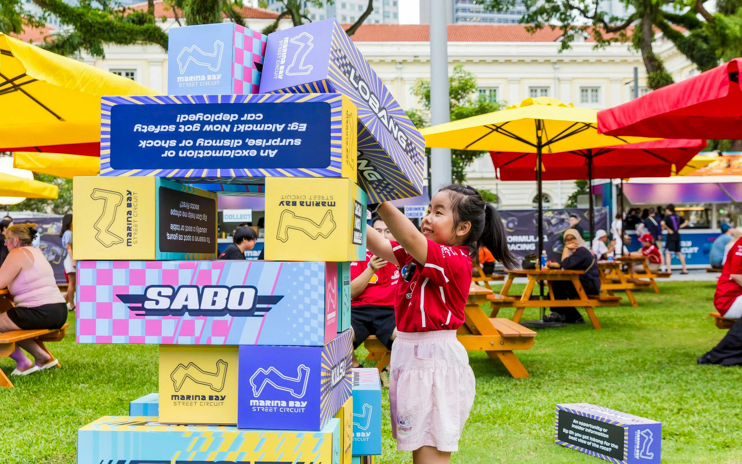 Child stacking blocks at Formula 1 Singapore Grand Prix, Marina Bay Street Circuit.