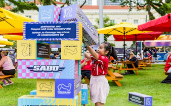 Child stacking blocks at Formula 1 Singapore Grand Prix, Marina Bay Street Circuit.