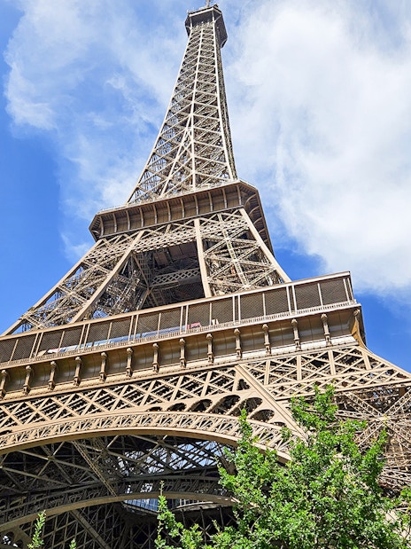 Eiffel Tower viewed from below with clear blue sky in Paris.