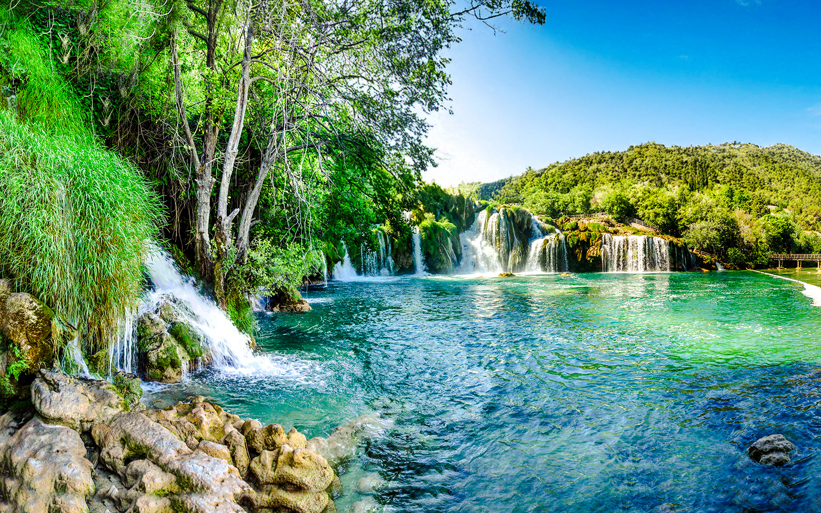 Aerial view of waterfalls and lush greenery at Plitvice Lakes, Croatia.