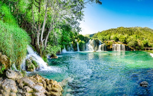 Aerial view of waterfalls and lush greenery at Plitvice Lakes, Croatia.