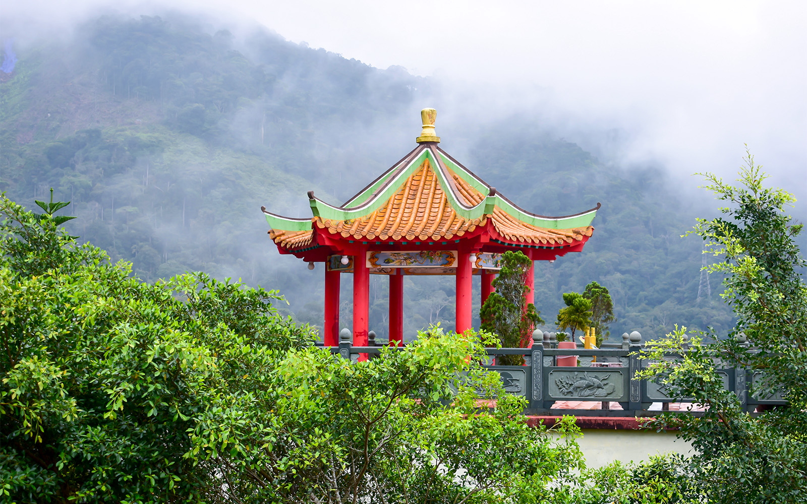 Chin Swee Caves Temple with intricate pagoda and lush forest backdrop in Genting Highlands, Malaysia.