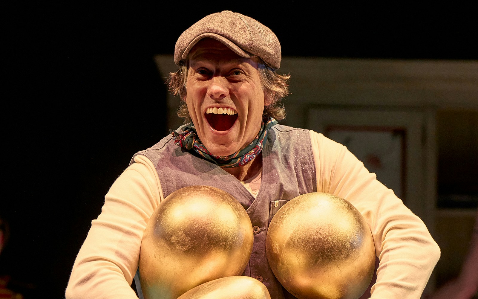 Mother Goose pantomime performance at London theater with vibrant stage set and actors.
