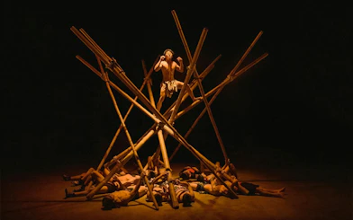 Performer balancing on bamboo structure at Teh Dar Vietnamese Bamboo Circus.