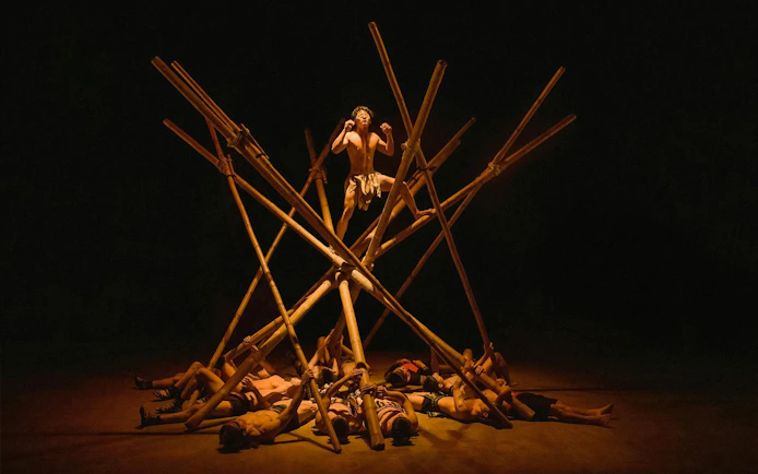 Performer balancing on bamboo structure at Teh Dar Vietnamese Bamboo Circus.