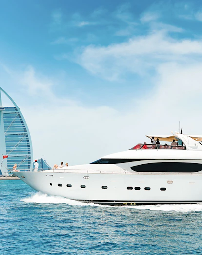 Luxury yacht cruising near Burj Al Arab, Dubai.