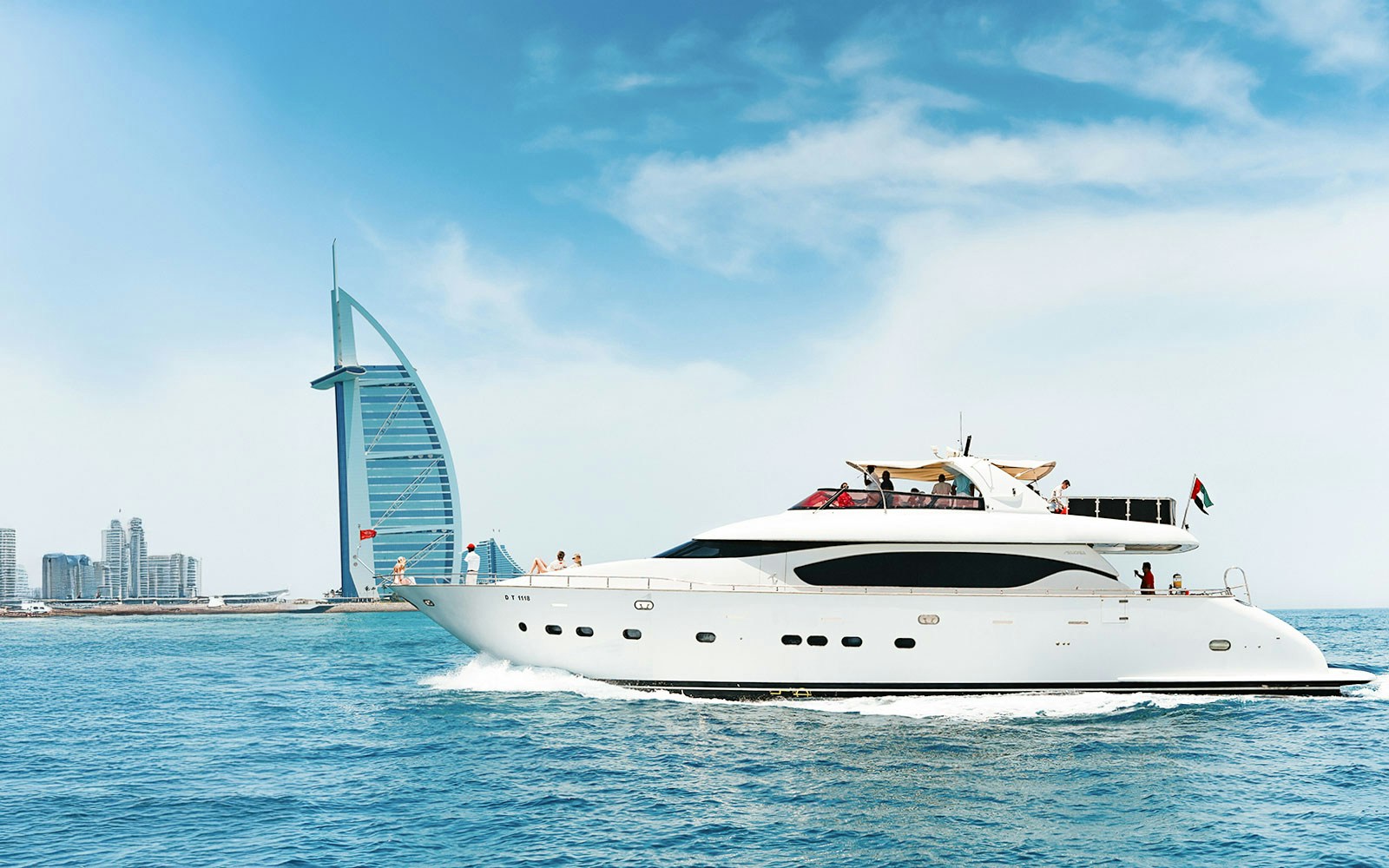 Dubai Marina luxury yacht cruise with city skyline in the background.