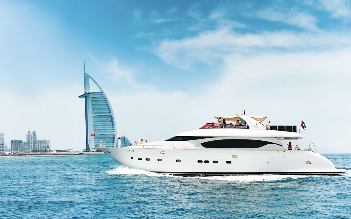 Luxury yacht cruising near Burj Al Arab, Dubai.