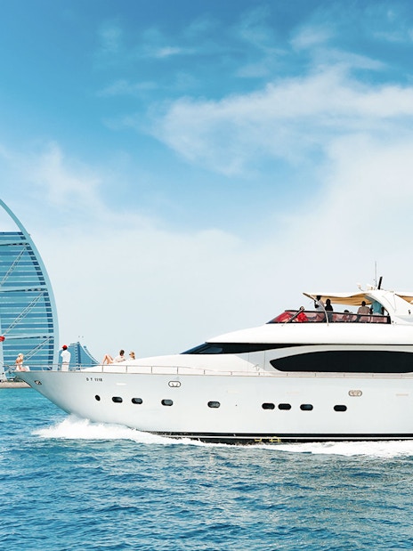 Luxury yacht cruising near Burj Al Arab, Dubai.