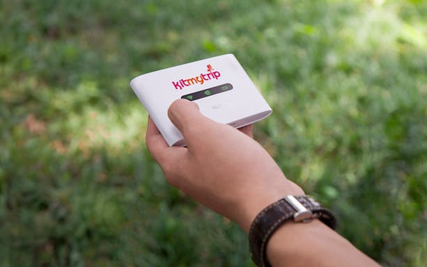 Hand holding 4G Pocket WiFi device for rental, available at DXB, AUH, SHJ airports.