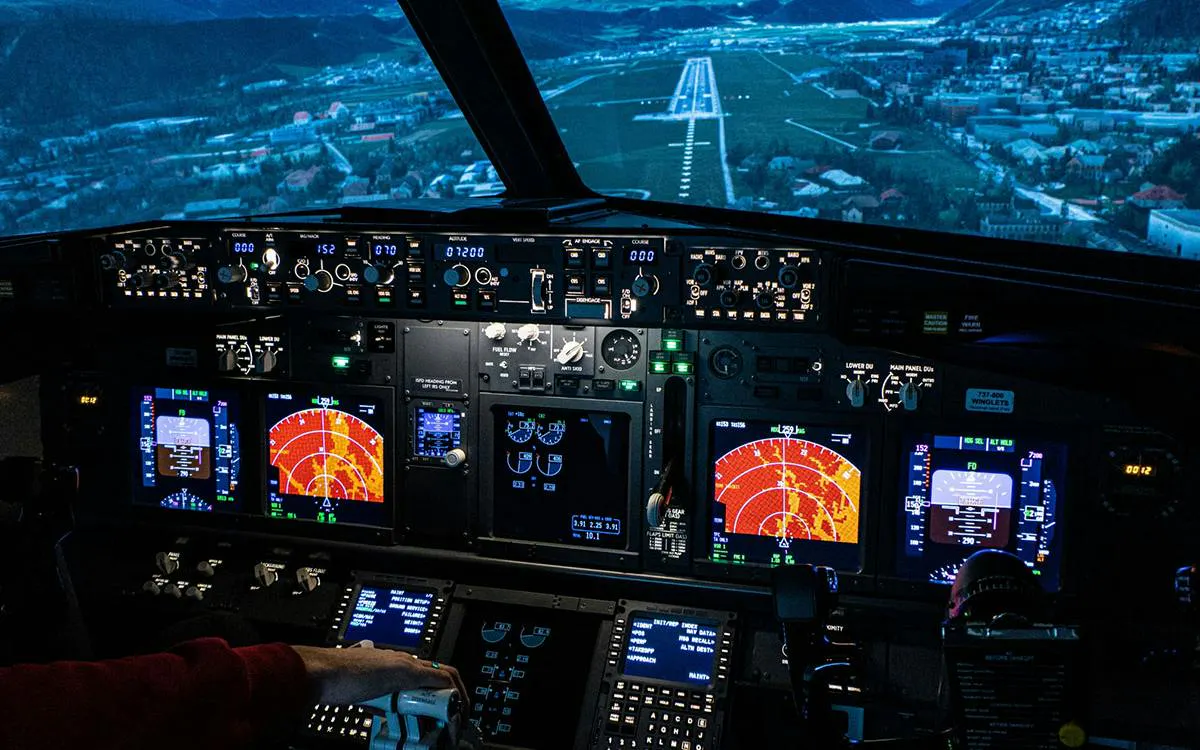 Boeing 737 cockpit simulator with pilot controls and runway view, Istanbul.