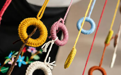 Colorful yarn rings hanging at Seulo Traditional Sardinian Weaving Workshop, Cagliari.