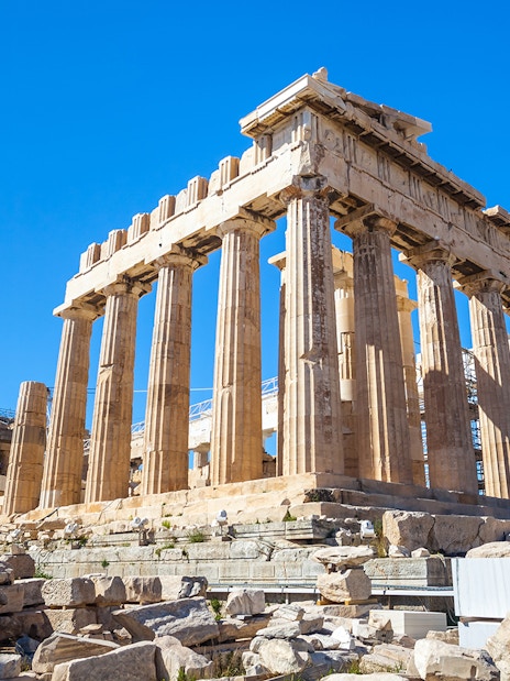 Parthenon temple on the Acropolis in Athens, Greece, under a clear blue sky.