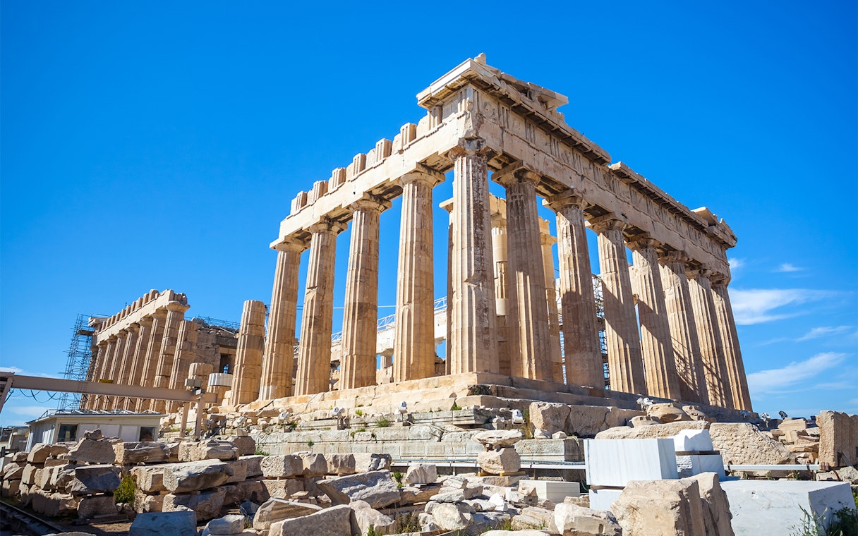 Parthenon temple on the Acropolis in Athens, Greece, under a clear blue sky.