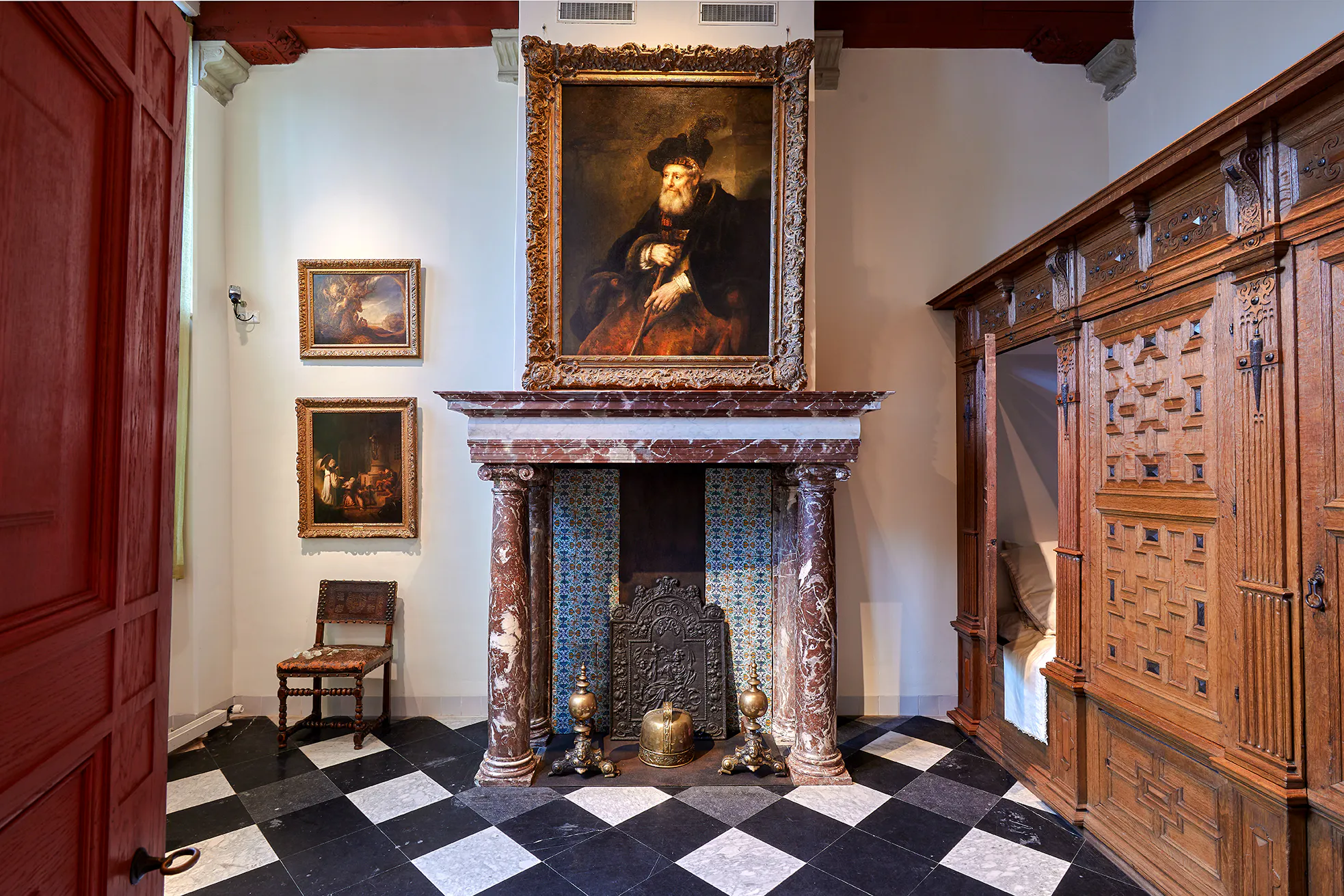 Rembrandt House Museum interior with paintings and ornate fireplace, Amsterdam.