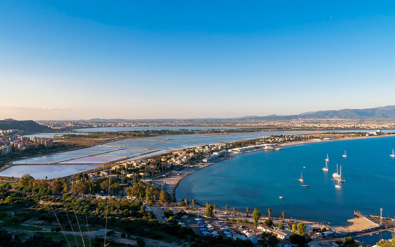 View of Cagliari coastline and salt pans from Devil’s Saddle hike in Sardinia, Italy.