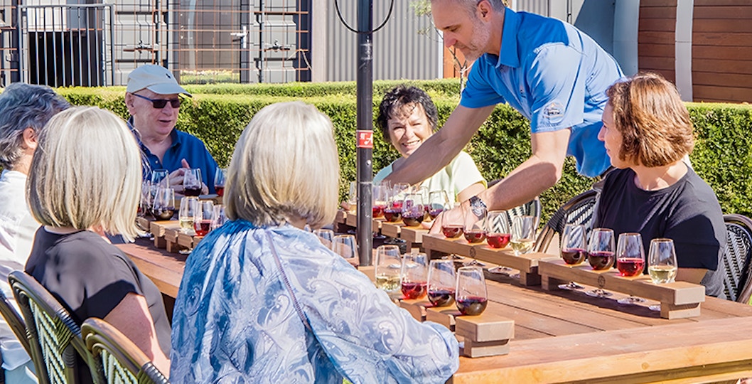 Host serving wine to the guests for tasting