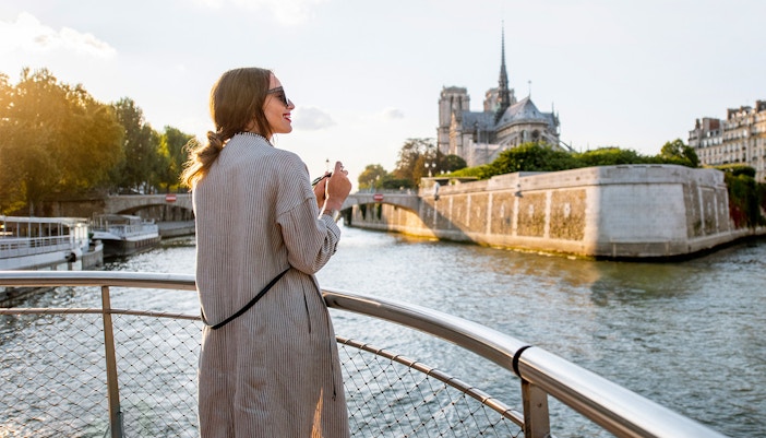 Seine River cruise participant viewing Eiffel Tower in Paris.
