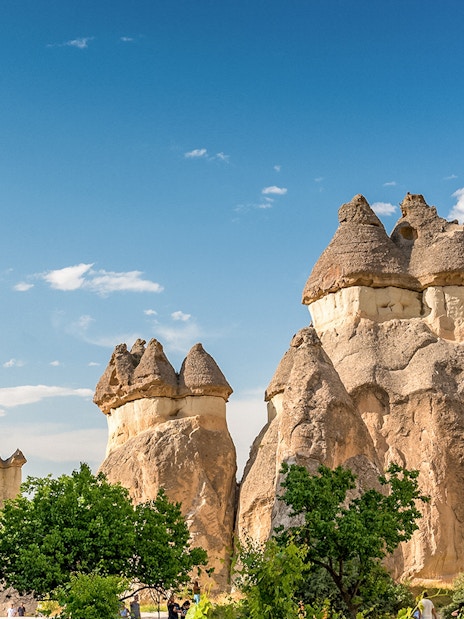 Fairy chimneys in Cappadocia, Turkey, under a clear blue sky.