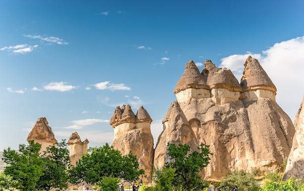 Fairy chimneys in Cappadocia, Turkey, under a clear blue sky.