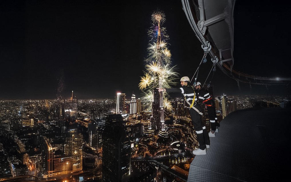Sky Views Observatory visitors watching Burj Khalifa fireworks in Dubai at night.