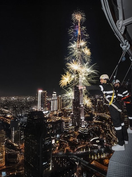 Sky Views Observatory visitors watching Burj Khalifa fireworks in Dubai at night.