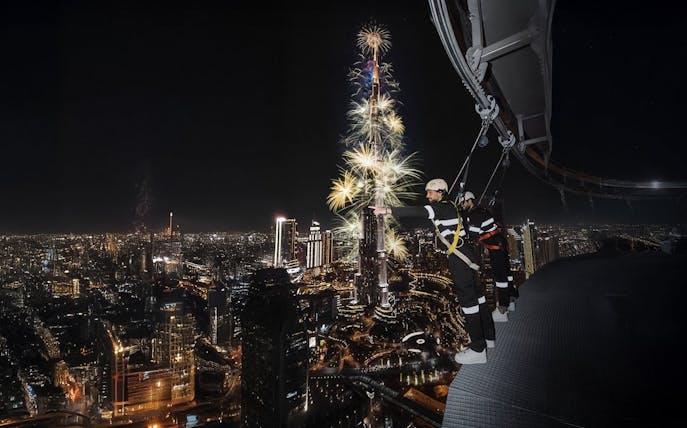 Sky Views Observatory visitors watching Burj Khalifa fireworks in Dubai at night.