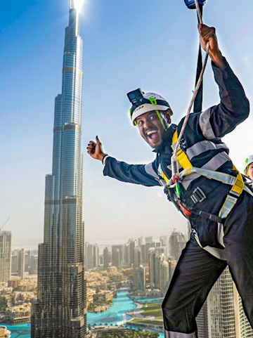 Person ziplining with Burj Khalifa view at Sky Views Observatory, Dubai.