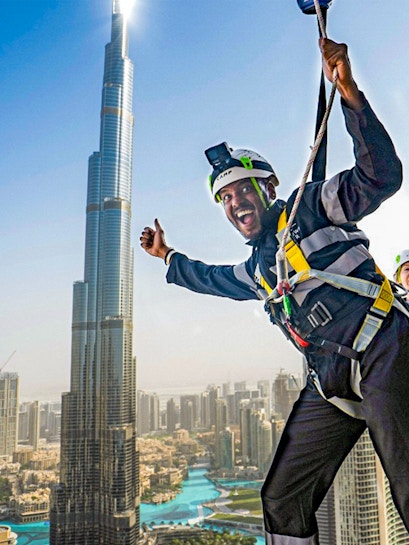 Person ziplining with Burj Khalifa view at Sky Views Observatory, Dubai.