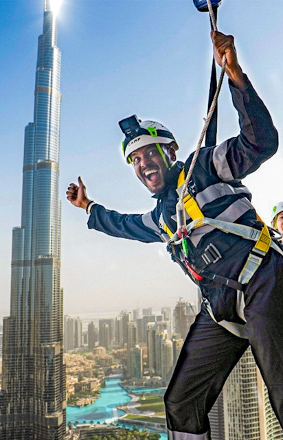 Person ziplining with Burj Khalifa view at Sky Views Observatory, Dubai.