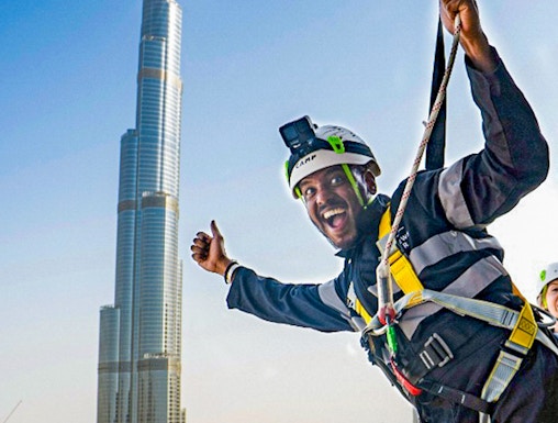 Person ziplining with Burj Khalifa view at Sky Views Observatory, Dubai.