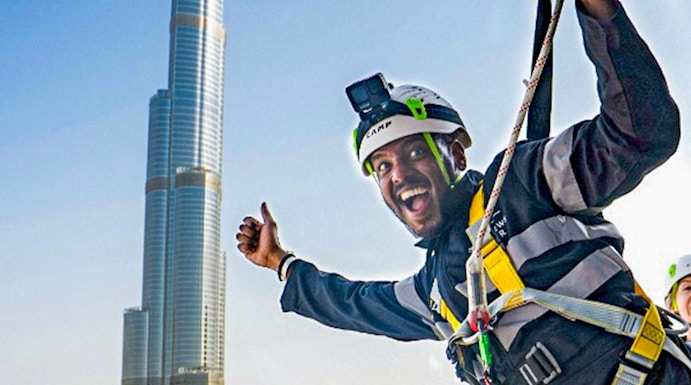 Person ziplining with Burj Khalifa view at Sky Views Observatory, Dubai.