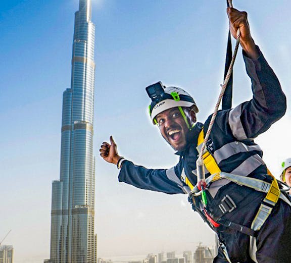 Person ziplining with Burj Khalifa view at Sky Views Observatory, Dubai.