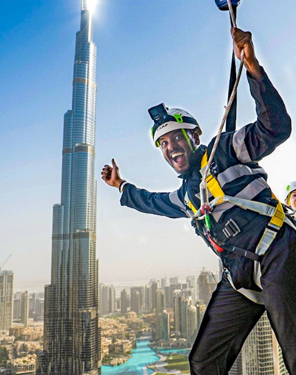 Person ziplining with Burj Khalifa view at Sky Views Observatory, Dubai.