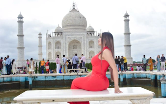 Visitors at the Taj Mahal with the iconic marble mausoleum in the background, Agra.