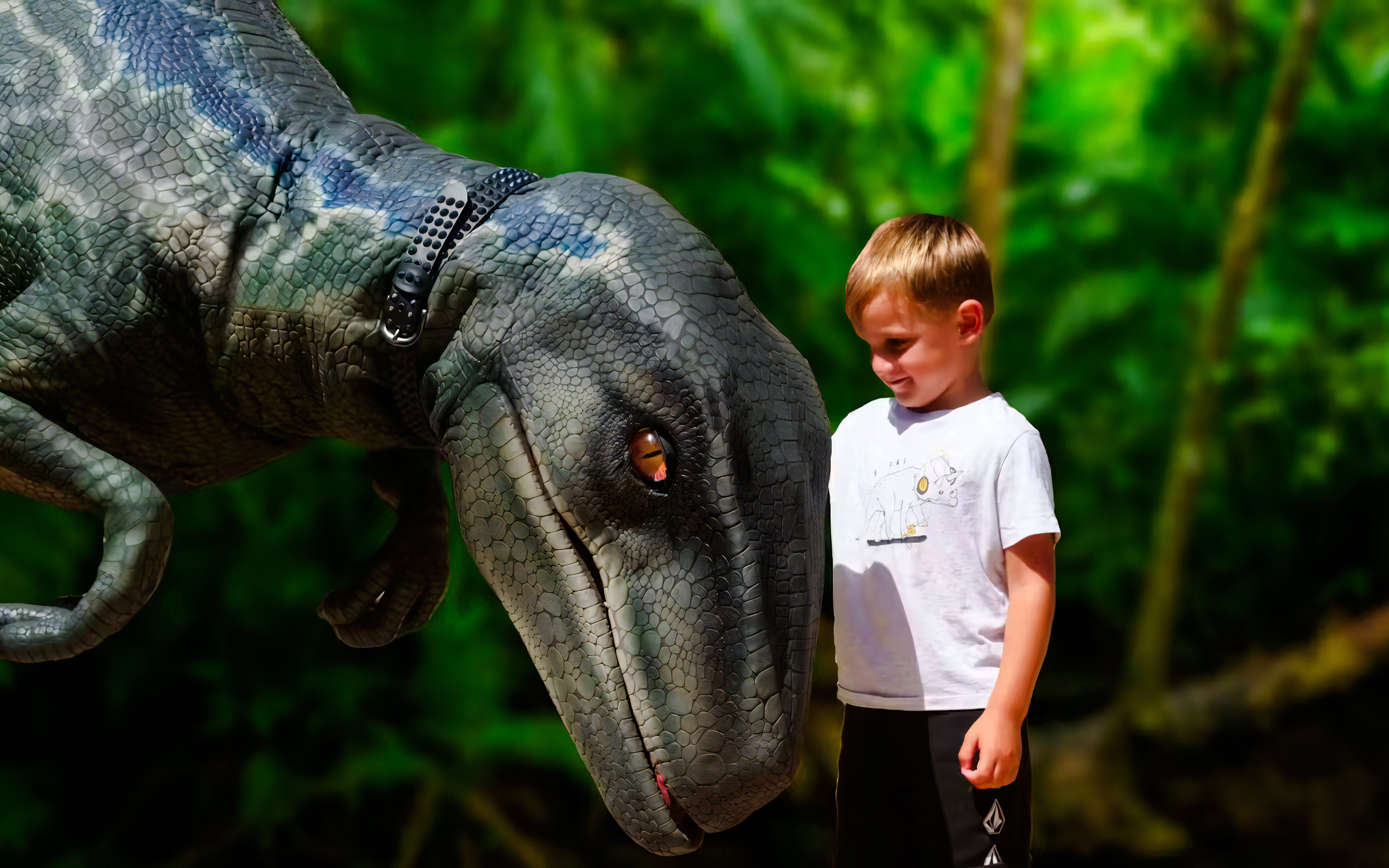 Child interacting with dinosaur model at Dinosaurland, Mallorca.