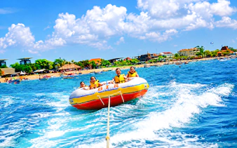 Tanjung Benoa ocean adventure with tourists on inflatable boat, Bali.