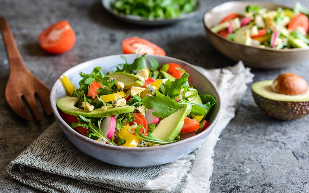 Salad with avocado, arugula, and tomatoes at International buffet, Good Old Days.